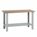Banco da lavoro con piano in legno impiallacciato in noce tanganika e bordato faggio spessore mm. 40, 2 fiancate e 1 sottopiano sagomato e rinforzato. Portata kg.1000. Smontato. Verniciatura a polvere grigio RAL 7038. Dimensioni: 150Lx75Px90Hcm. Fornito s